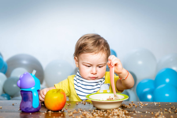 Cute baby food, babies eating. Funny kid boy with plate and spoon. - Zdjęcie, obraz