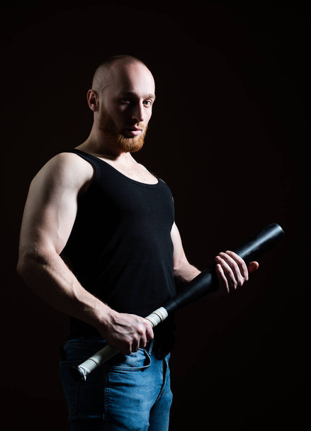 Brutal angry gang man lifestyle, serious handsome guy. Brutal man with baseball bat for fighting, concept of men power and strong. Violence and aggression. Dangerous man with serious emotion. - Photo, image