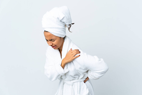 Young woman in bathrobe over isolated white background suffering from pain in shoulder for having made an effort - Foto, immagini
