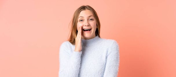 Teenager Ukrainian girl isolated on pink background with surprise and shocked facial expression - Foto, imagen