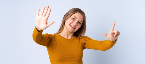 Teenager Ukrainian girl isolated on blue background counting seven with fingers - Photo, Image