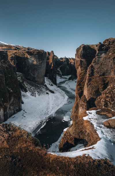 Aerial Drone view of Fjadrargljufur canyon and Fjadra river at winter. White snow and blue river. Iceland near Reykjavik. - 写真・画像