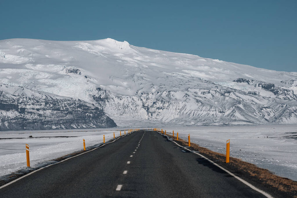 Landscape the road in winter, road trip on the country road in sunrise at Iceland with blue sky and snow covered mountains. - Foto, imagen