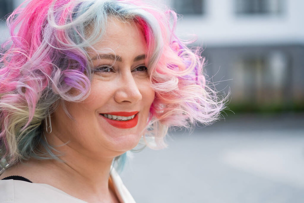 Close-up portrait of curly Caucasian woman with multi-colored hair. Model for hairstyles - Фото, зображення