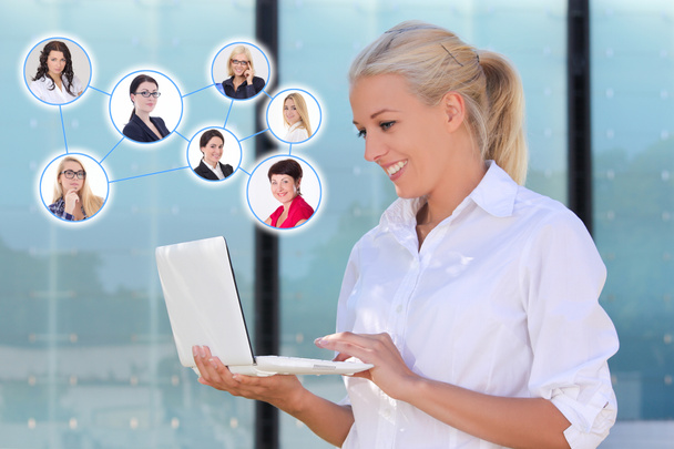 Social network concept - business woman with laptop in the stree - Photo, Image