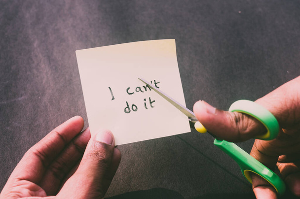 Hands cutting letter T with scissors with written text i can't do it. Business concept for determination Success Challenge self believe Motivation and aspirations to achieve results Aim goal. - Photo, Image