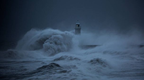 Los vientos de la fuerza de vendaval de Storm Arwen hacen que olas gigantes golpeen el faro y el muelle norte protegiendo la boca del Tyne en Tynemouth, Inglaterra - Foto, Imagen