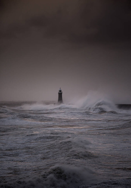 The gale force winds from Storm Arwen cause giant waves to batter the lighthouse and north pier guarding the mouth of the Tyne in Tynemouth, England - Fotó, kép