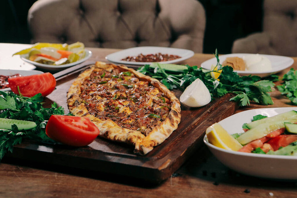 Traditional turkish baked dish pide. Turkish pizza pide, Middle eastern appetizers. Turkish cuisine. Pide with meat filling - Фото, зображення