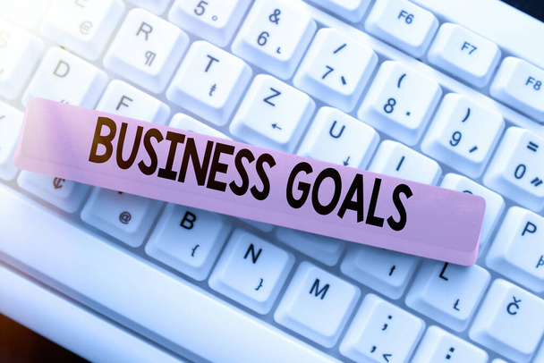 Writing displaying text Business Goals. Business showcase Expectation to accomplish over a specific period of time Typing Advance Lesson And Lecture Plans, Typewriting New Article Pages - Фото, изображение