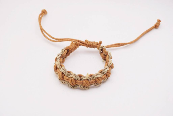 An isolated ethnic bracelet on white background. The bracelet is made off the various rope - Фото, зображення