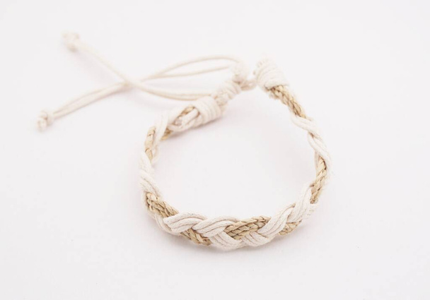 An isolated ethnic bracelet on white background. The bracelet is made off the various rope - Foto, Imagem