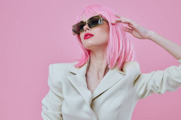 Retrato de una encantadora dama de estilo moderno pelo rosa gafas de sol fondo rosa inalterado - Foto, Imagen