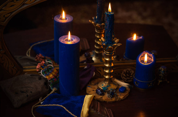 Candle burns on the altar, magic among candles, clean energy, magical concept - Fotó, kép