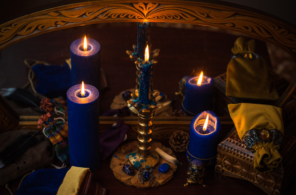 Candle burns on the altar, magic among candles, clean energy, magical concept - Фото, изображение