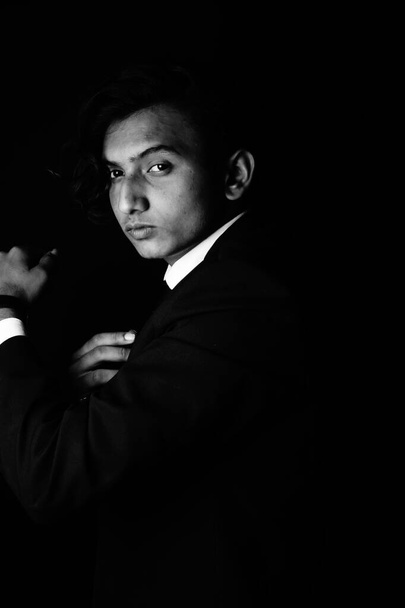 portrait of a young man in a suit on a black background  - Φωτογραφία, εικόνα