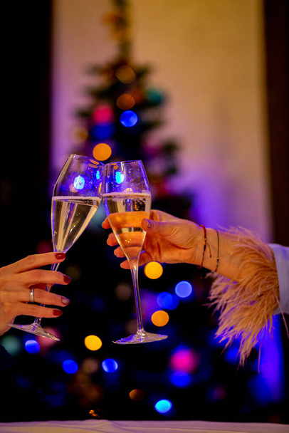 Champagne for the holiday. Champagne on the background of a Christmas tree - Foto, Imagem