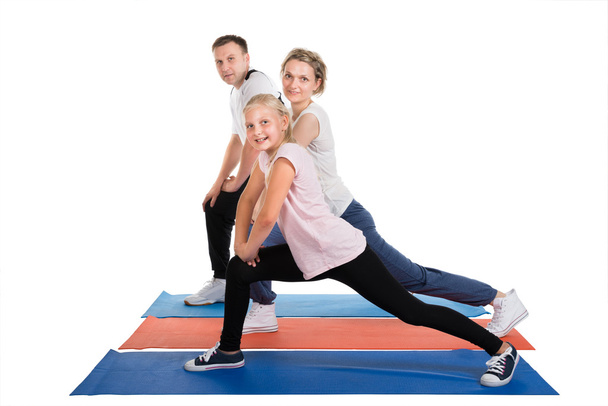 Young Family Doing Stretching Exercises - Φωτογραφία, εικόνα