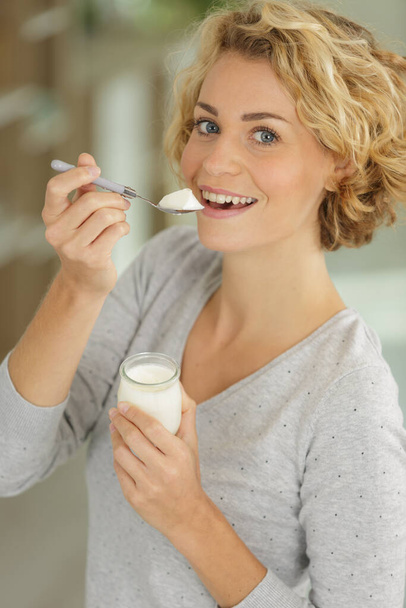 bright picture of beautiful woman with yogurt - 写真・画像