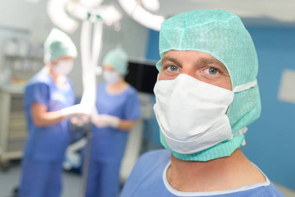 surgeon in mask standing in a modern operating room - Photo, image