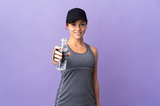 Teenager Russian girl isolated on purple background with sports water bottle - Foto, immagini