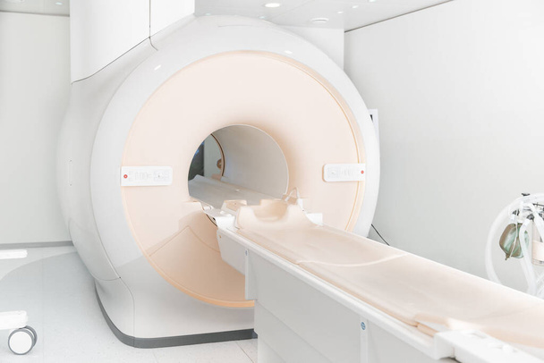 Medical CT or MRI Scan in the modern hospital laboratory. Interior of radiography department. Technologically advanced equipment in white room. Magnetic resonance diagnostics machine - Photo, Image