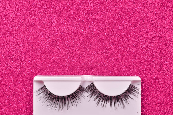 Pink background with false lashes copy space . High quality photo - Photo, Image