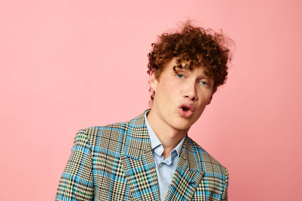 cute red-haired guy gesturing with his hands emotions checkered jacket isolated background unaltered - Zdjęcie, obraz