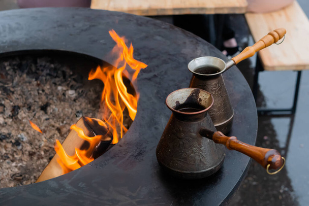 Подготовка турецкого кофе с черным чезе или ибриком на фестивале уличной еды - Фото, изображение