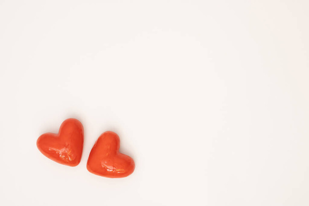 Red hearts on white background. Love or Valentine's day concept. Minimal, flat lay. - Fotoğraf, Görsel