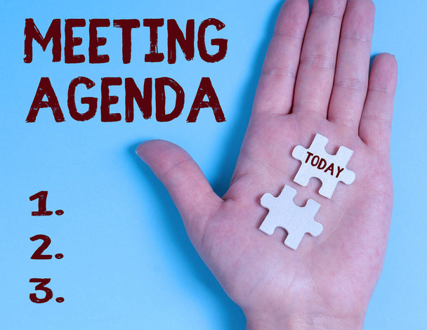 Tekst met inspiratie Meeting Agenda. Word Written on An agenda set clear expectations for what needs to a meeting Building An Unfinished White Jigsaw Pattern Puzzle With Missing Last Piece - Foto, afbeelding