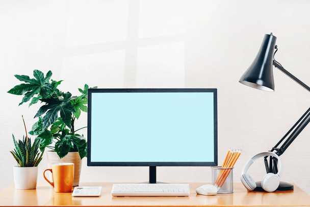 Front view of a workspace modern computer . Blank mockup screen - 写真・画像