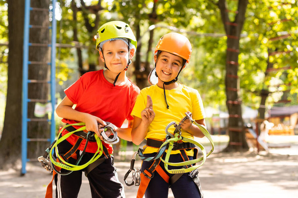 Boldog gyermek hegymászó a fák. Kötél Park. Climber gyermek. Koragyermekkori fejlődés. Roping parkban. Balance gerenda és kötél hidak. Kötélpálya-mászóközpont - Fotó, kép