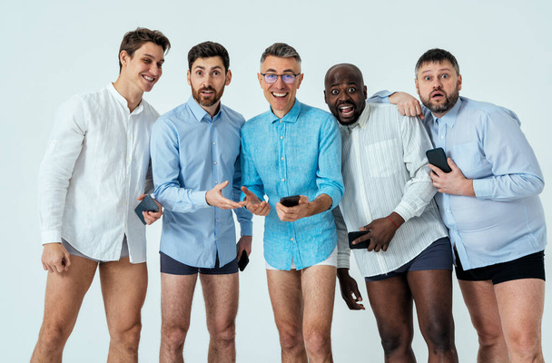 multiethnic men posing for a male edition body positive beauty set.  guys with different age, and body wearing boxers underwear and shirt - Foto, Bild