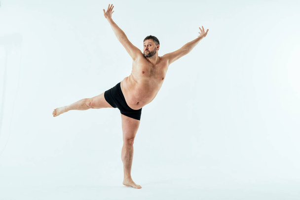 Man posing for a male edition body positive beauty set. Shirtless guy wearing boxers underwear in studio - Φωτογραφία, εικόνα