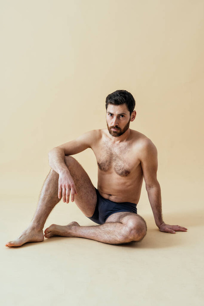man posing for a male edition body positive beauty set. Shirtless guy wearing boxers underwear in studio - Foto, Imagen