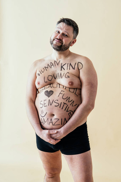 man posing for a male edition body positive beauty set. Shirtless guy wearing boxers underwear in studio - Foto, Bild