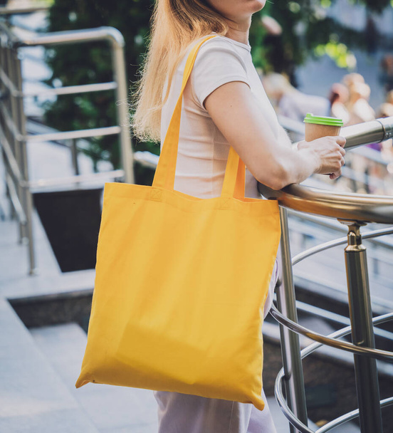 Young beautiful woman with linen eco bag on city background. - Φωτογραφία, εικόνα