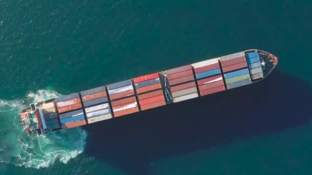 Sea container ship is moving at sea. Around the foam from the work of the screw. View of the ship from above. - Filmati, video