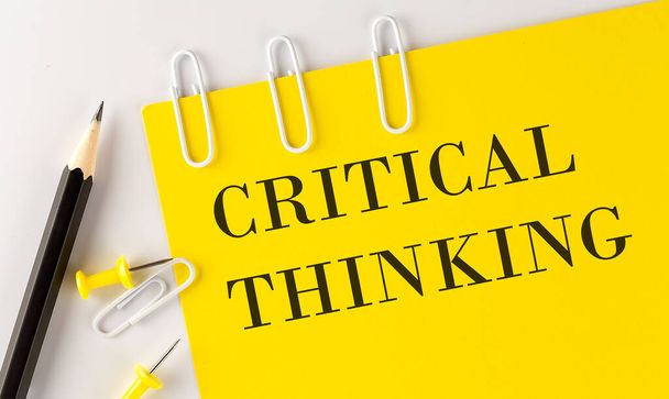 CRITICAL THINKING word on the yellow paper with office tools on the white background - Foto, immagini