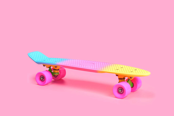 rainbow plastic Penny board skateboard isolated on pink background - Photo, Image