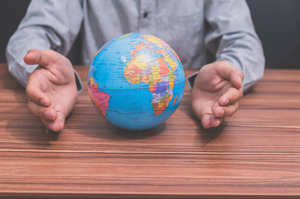 A person holding the globe figure - world energy saving concept - Фото, зображення