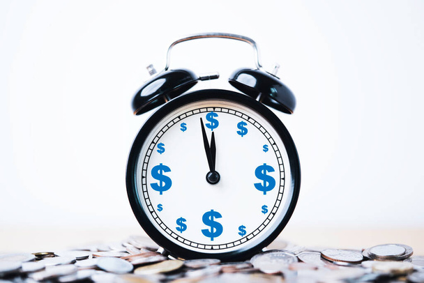 Zaman ve para yönetimi kavramı için para yığınının üzerindeki alarm saati içindeki dolar işareti ekranı. - Fotoğraf, Görsel
