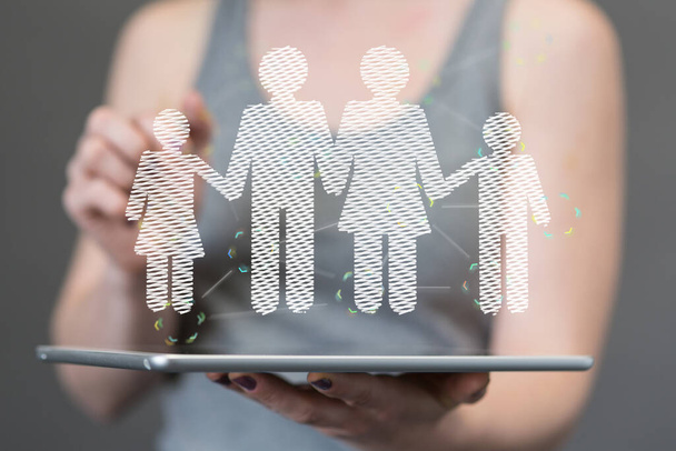 A hologram of a family floating on the tablet being held by a person - Foto, Imagen