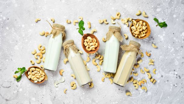 Nut lactose-free milk. Homemade milk from cashew nuts in a bottle. Top view. - Fotoğraf, Görsel