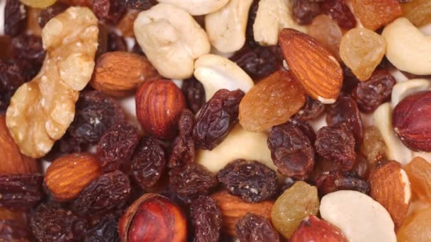 spinning nuts. close-up of nut mixture slow motion - Felvétel, videó