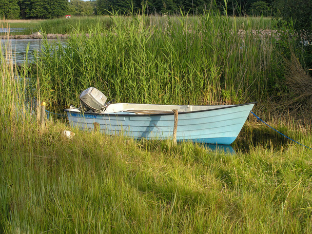 A small rowing boat next to the shore in Karlskrona, Sweden - Photo, Image