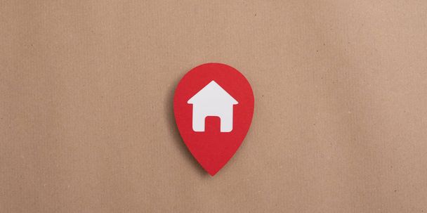 A sign of the home on the red background - the concept of the real estate protection - Фото, изображение