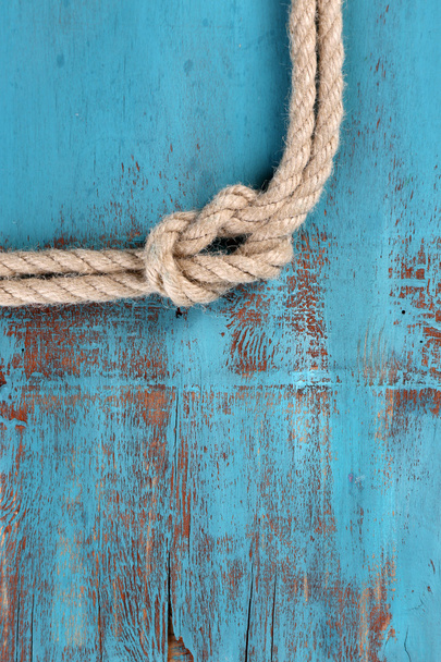 Marine knot on wooden background - Foto, afbeelding