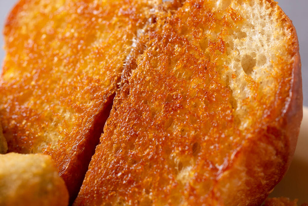A closeup view of the texture of buttered Texas toast. - Fotó, kép
